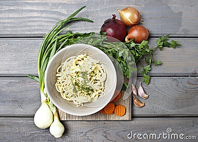Top view on bowl of spaghetti and fresh vegetables