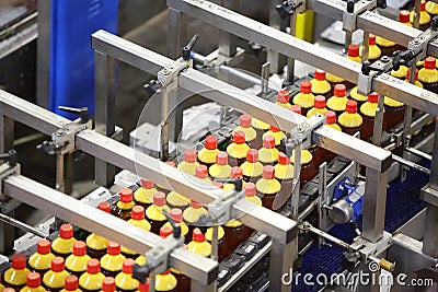 Top view of conveyor with bottles with fresh light beer