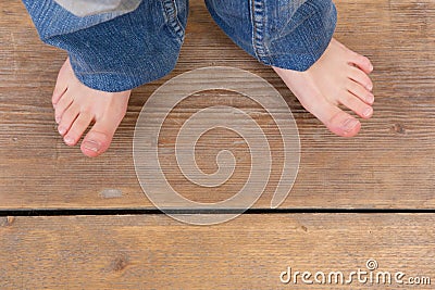 Top view of jeans and feet from a little girl