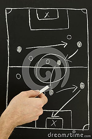 Top view of a man drawing a football game strategy