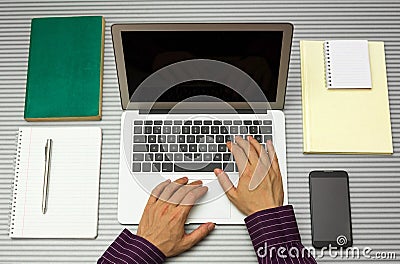 Top view of man working with laptop in office or at home