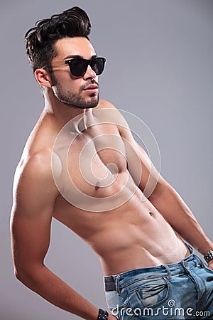 Topless man with hand in back pocket