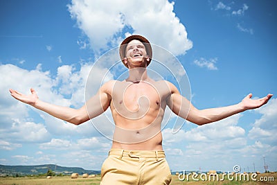 Topless man laughing outdoor with arms wide open