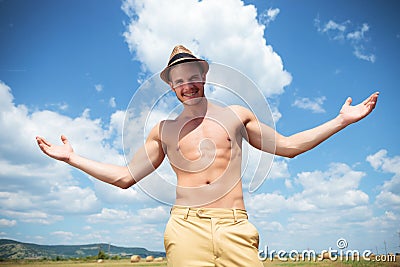 Topless man outdoor looks at you with arms wide open