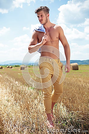 Topless man outdoor walking and looking away