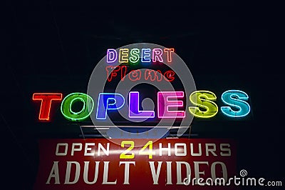 Topless neon sign advertising a strip club