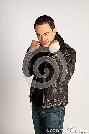 Tough man in leather jacket in fighting pose