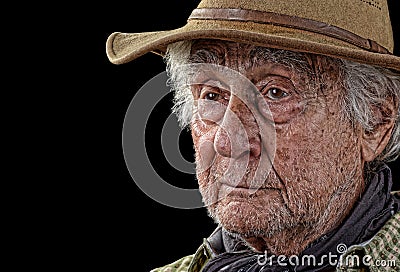 Tough old rancher isolated on black