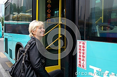 Tourist enters to the bus in China