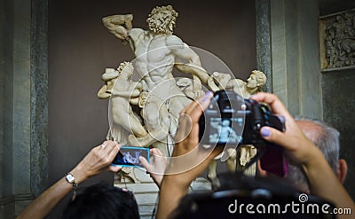 Tourist photograph the Laocoon Sculpture in the Vatican Museum, Vatican City, Rome, Italy.