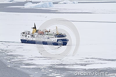 Tourist ship breaking ice in the strait of the Antarctic Peninsu