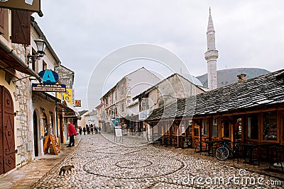 Tourist watch the showcases of small shops on the