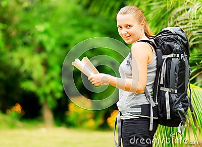 Young woman with backpack in a woods