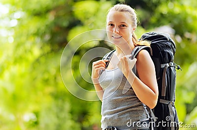 Young woman with backpack in a woods