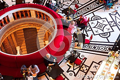 Tourists drink coffee in cafe inside the museum