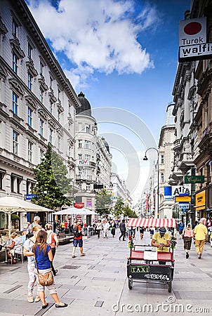 Tourists form all over the World walks among one of the main streets, Kartner Strasse in Vienna, Austria.