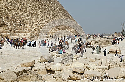 Tourists near famous Egyptian pyramids