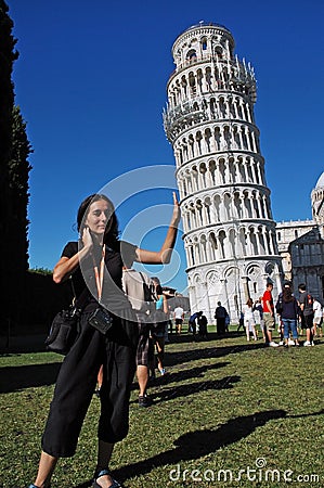 Tourists posing with the Leaning Tower, Pisa, Italy