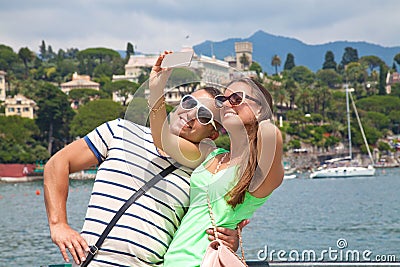 Tourists taking a picture in France with their phone