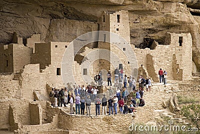 Tourists viewing kiva at Cliff Palace cliff