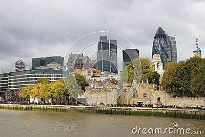 Tower of London and Modern London city office skyline by River Thames