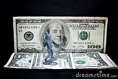 Toy soldier standing with dollar