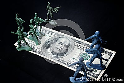 Toy soldier standing with dollar
