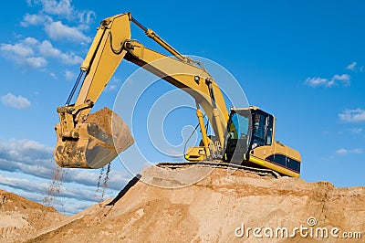 Track-type loader excavator at sand