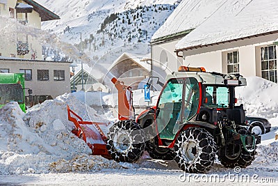 Tractor blower cleaning snow in street