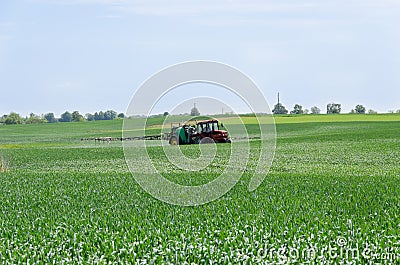 Tractor nozzles fertilizing crops field