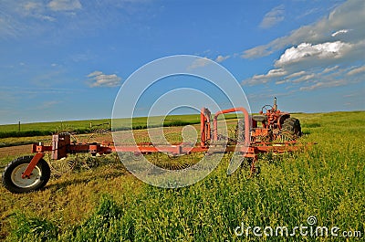 Tractor and Rake Parked in Hay Field