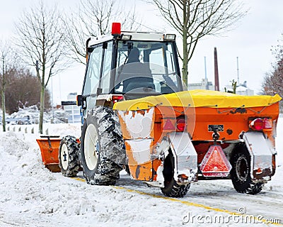 Tractor removes snow in a park