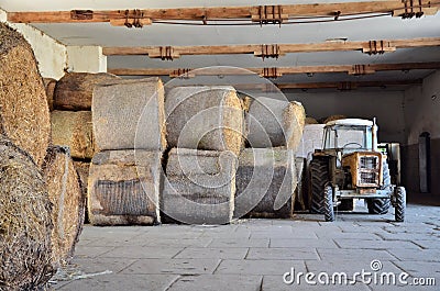 Stock Photos: Tractor and round bale of straw