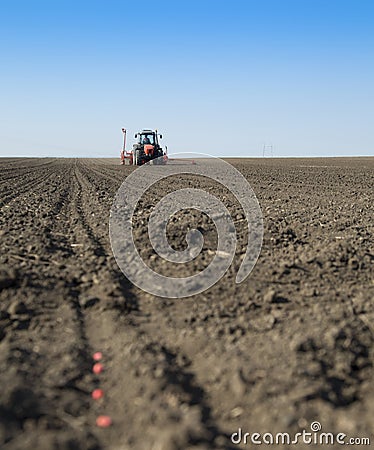 Tractor seeding crops at field