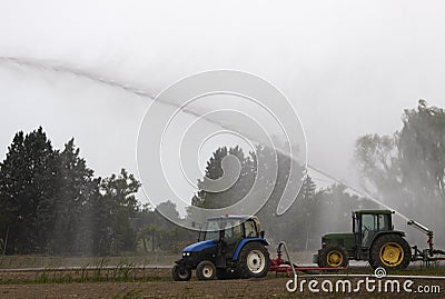 Tractors pump water in the field