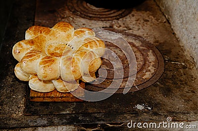 Traditional eastern lepeshka nan - white flat bread baked in old