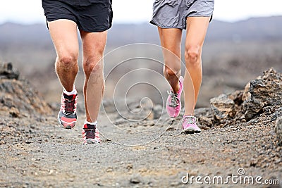 Trail running - close up of runners shoes and legs
