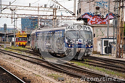 Train moving out of a station covered in graffiti in Zagreb, Cro