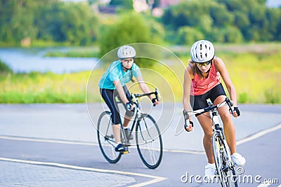 Training cycle of the two female caucasian sportswomen riding s