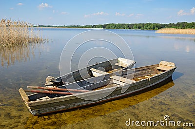 Transparent lake with small wooden boats