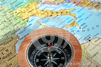 Travel destination Italy, compass with a map on the background