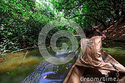 Travel by native style canoe in africa forest