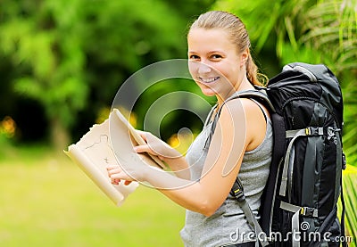 Young woman with backpack in a woods