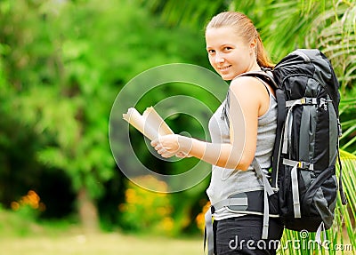 Young woman with backpack in a woods