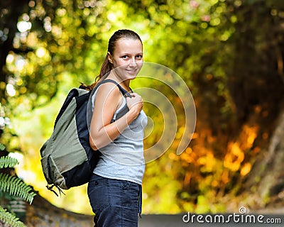 Young woman with backpack in a woods