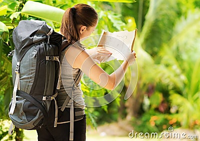 Young woman with backpack in a woods
