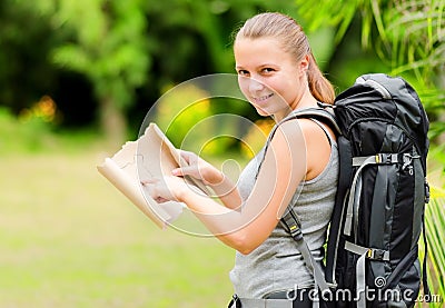 Young woman with backpack in a woods