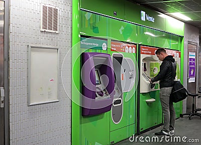 Traveler buying subway tickets