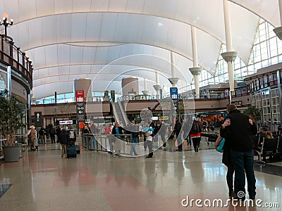 Travelers Embrace in Denver Airport (DIA) Lobby