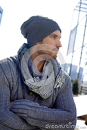 Trendy young man in hat and scarf